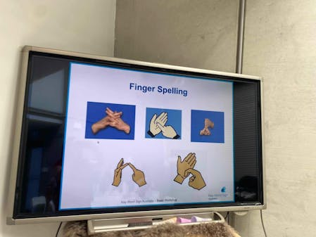 Screen showing finger spelling in sign language