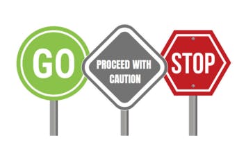 Three lollipop signs with the words "Go", "Proceed with caution" and "Stop"