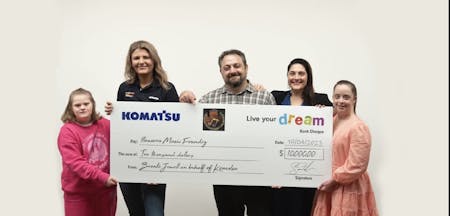 5 people standing with large Komatsu Live Your Dream cheque